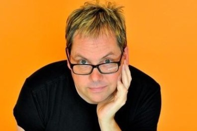 Man posing for camera with yellow background